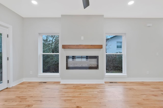 unfurnished living room featuring light wood-type flooring