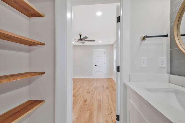 bathroom featuring hardwood / wood-style flooring, vanity, and ceiling fan