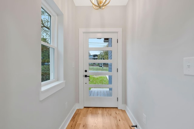 doorway featuring plenty of natural light and light hardwood / wood-style floors