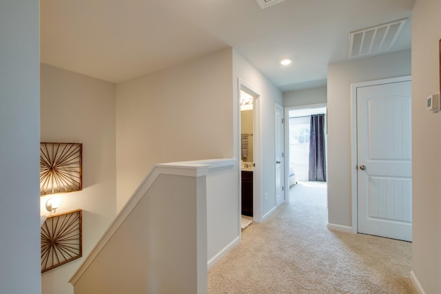 corridor featuring light carpet