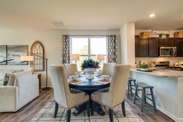 dining space with dark hardwood / wood-style floors