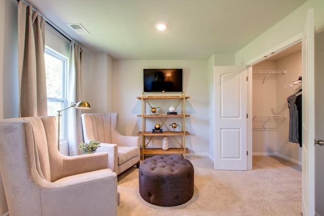 sitting room featuring light carpet