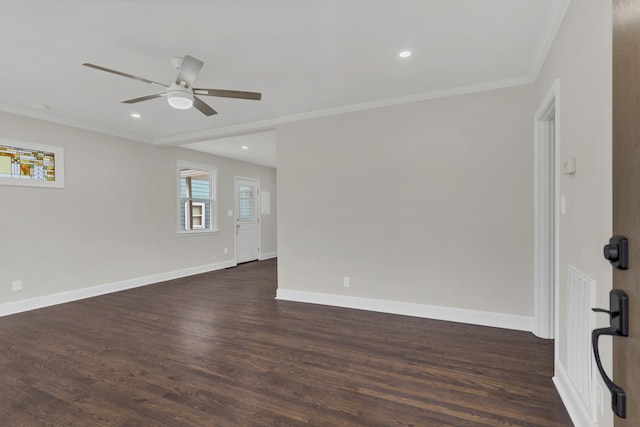 spare room featuring crown molding, dark hardwood / wood-style floors, and ceiling fan