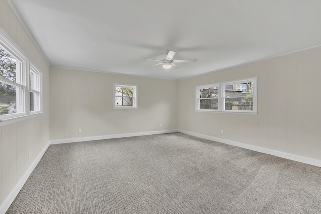 carpeted empty room featuring ceiling fan