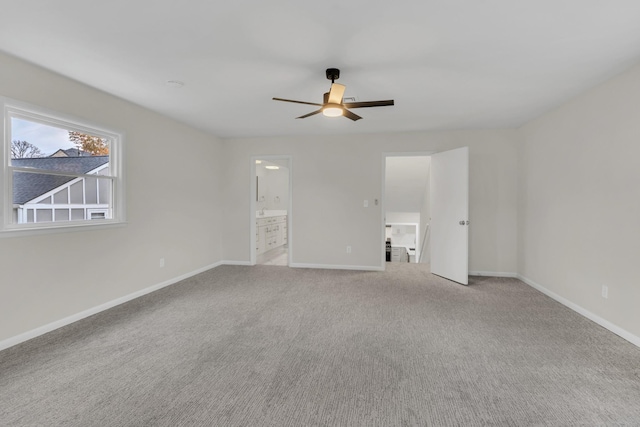 carpeted empty room featuring ceiling fan