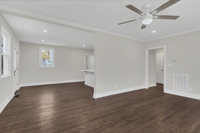 empty room with dark hardwood / wood-style flooring, ornamental molding, and ceiling fan