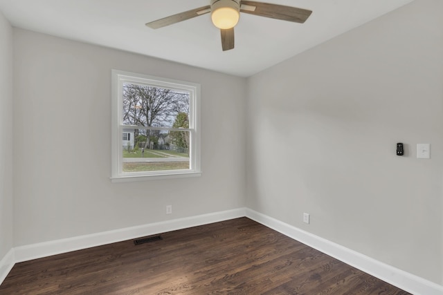 unfurnished room featuring dark wood-type flooring and ceiling fan