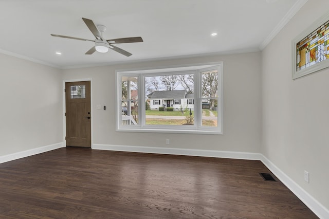 entryway featuring dark wood-type flooring, ceiling fan, and ornamental molding