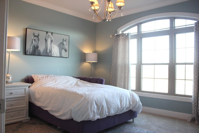 bedroom with multiple windows, a notable chandelier, ornamental molding, and dark colored carpet