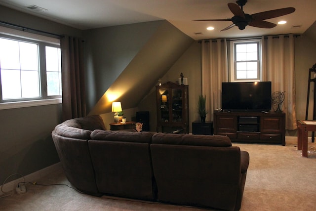 living room with light carpet, ceiling fan, vaulted ceiling, and a healthy amount of sunlight