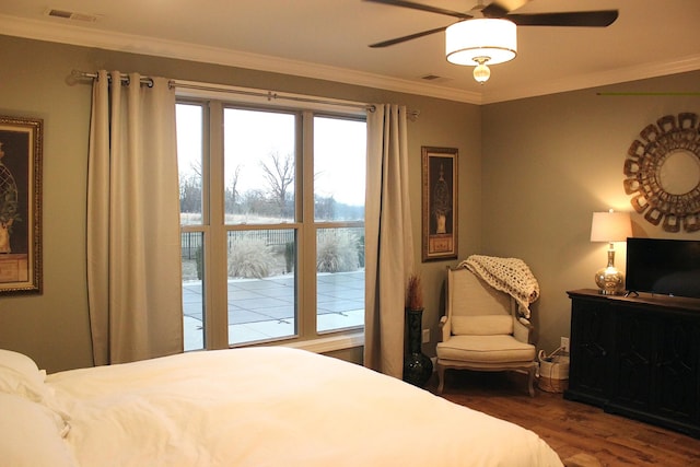 bedroom featuring ornamental molding, dark wood-type flooring, and ceiling fan