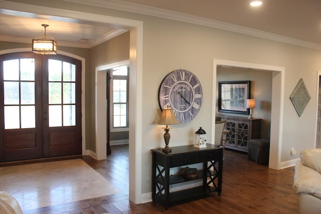 entrance foyer featuring ornamental molding, dark hardwood / wood-style floors, and french doors