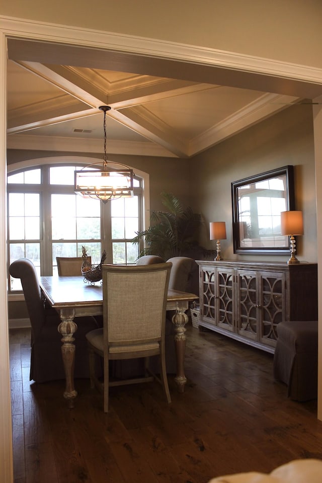 dining room with coffered ceiling, crown molding, dark wood-type flooring, and a notable chandelier