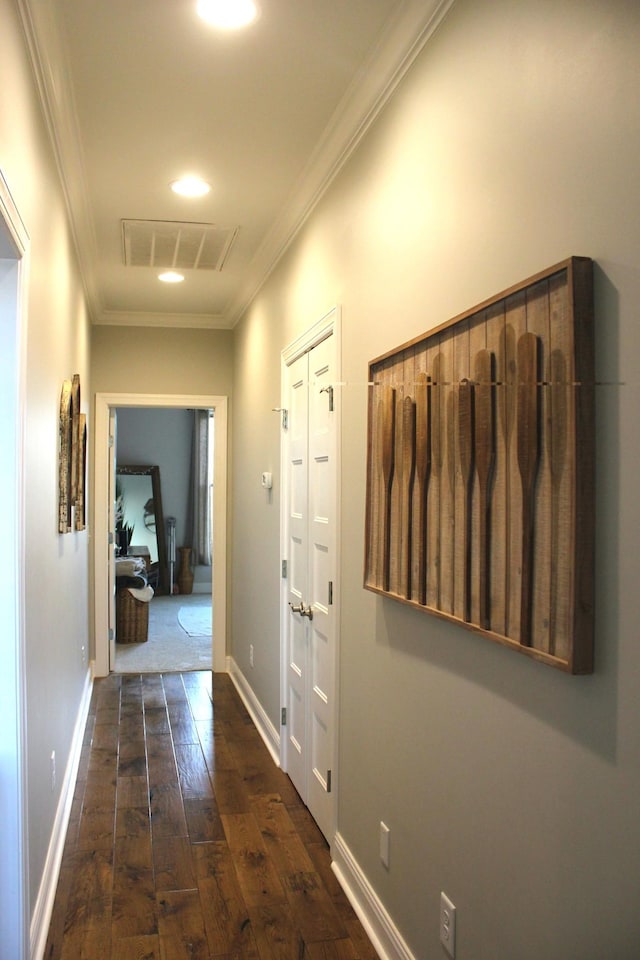 hallway featuring dark wood-type flooring and ornamental molding