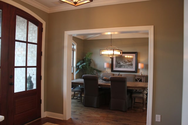 entrance foyer featuring ornamental molding and dark wood-type flooring