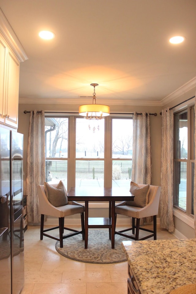 dining room featuring a notable chandelier and ornamental molding