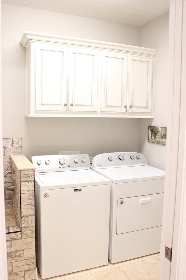 laundry area featuring cabinets and washing machine and dryer