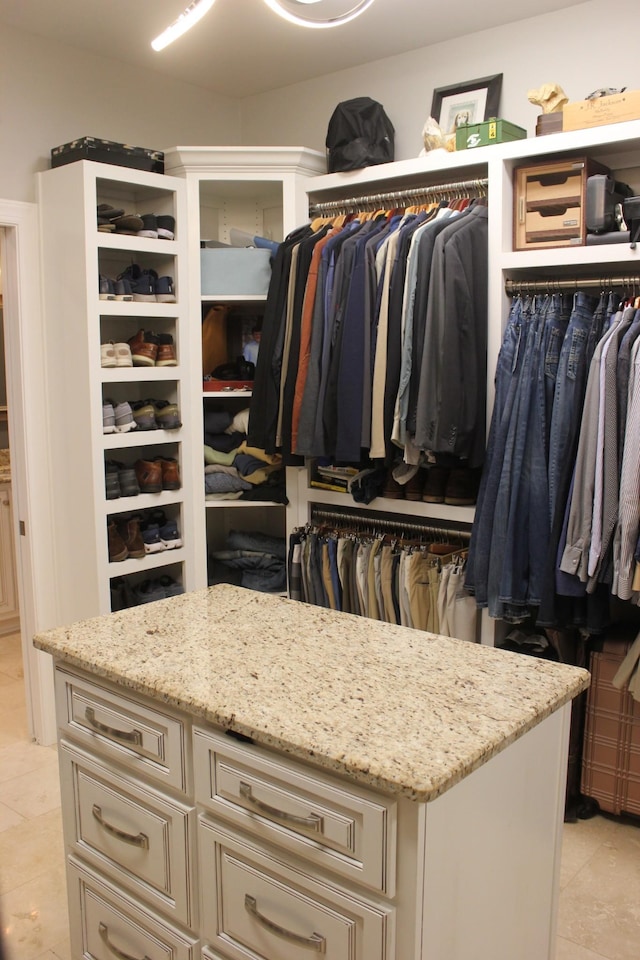 walk in closet featuring light tile patterned flooring