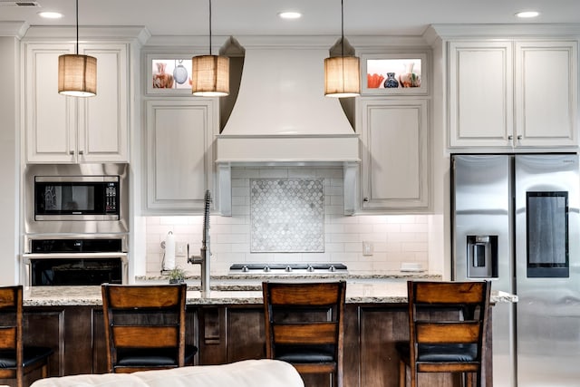 4888 Rock House Rd, Portland, TN 37148 - kitchen with a kitchen bar, appliances with stainless steel finishes, custom range hood, and hanging light fixtures