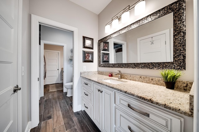 4888 Rock House Rd, Portland, TN 37148 - bathroom with toilet, wood finished floors, vanity, and baseboards