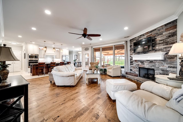 4888 Rock House Rd, Portland, TN 37148 - living room featuring crown molding, ceiling fan, light wood-style flooring, and a fireplace