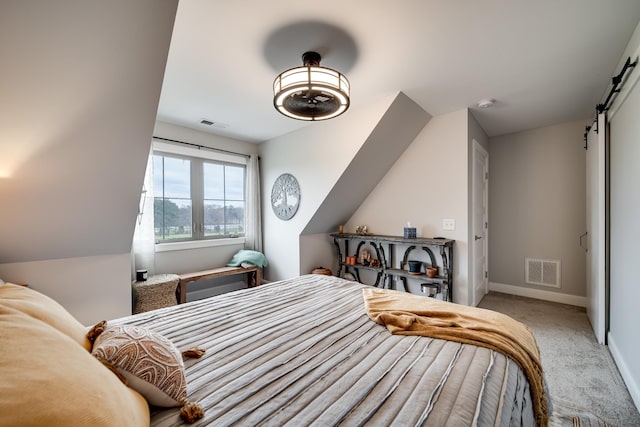 4888 Rock House Rd, Portland, TN 37148 - carpeted bedroom with a barn door, visible vents, and baseboards