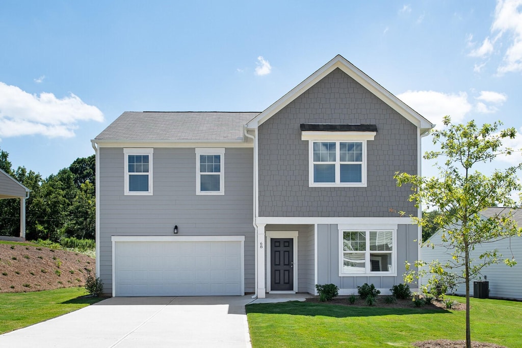 view of front of home with a garage and a front yard