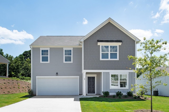 view of front of home with a garage and a front yard