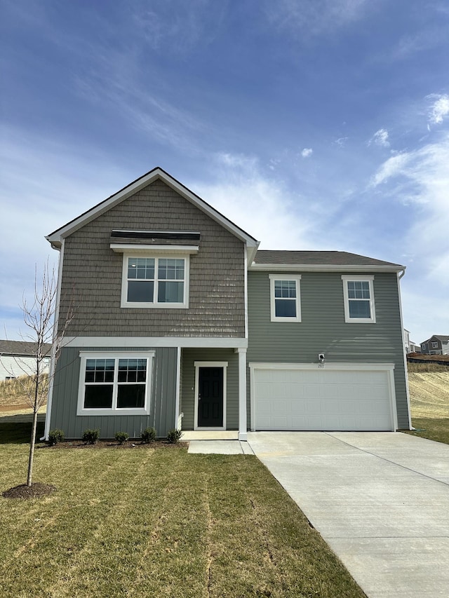 view of front of property with concrete driveway, a front lawn, and an attached garage