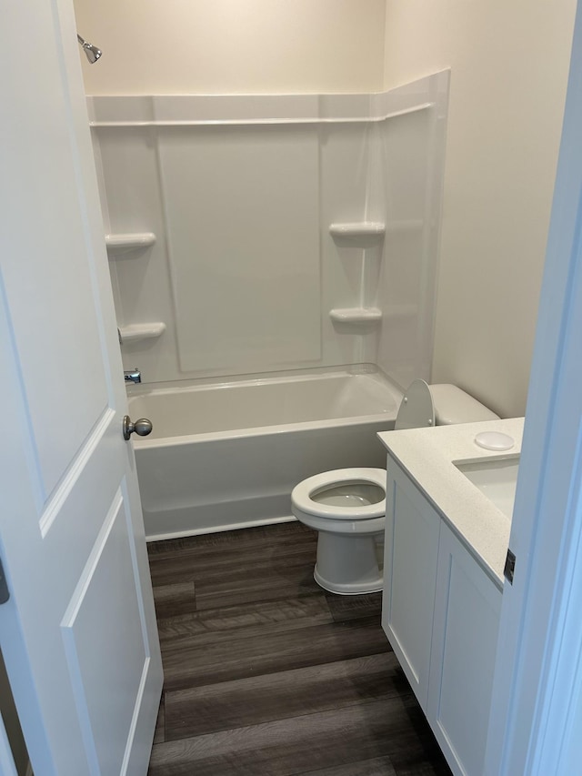 full bathroom featuring shower / bathing tub combination, toilet, wood finished floors, and vanity
