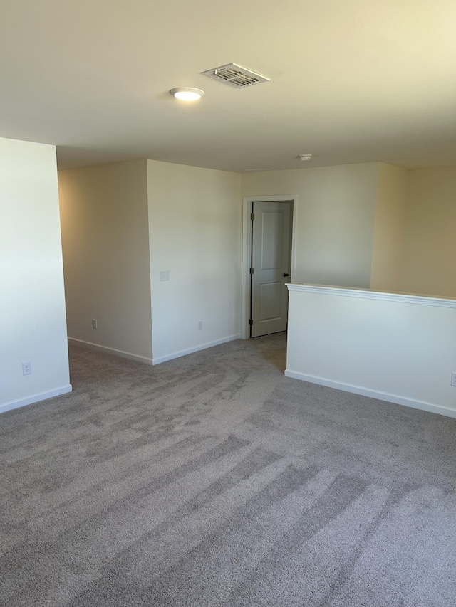 empty room with light carpet, baseboards, and visible vents