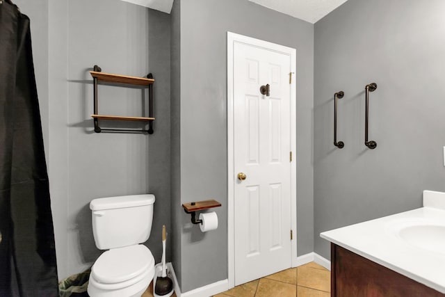 bathroom featuring tile patterned flooring, vanity, and toilet