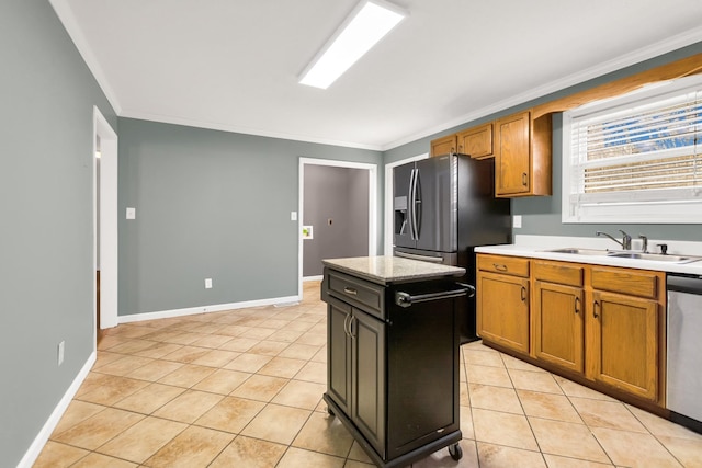 kitchen featuring a kitchen island, appliances with stainless steel finishes, sink, light tile patterned floors, and crown molding