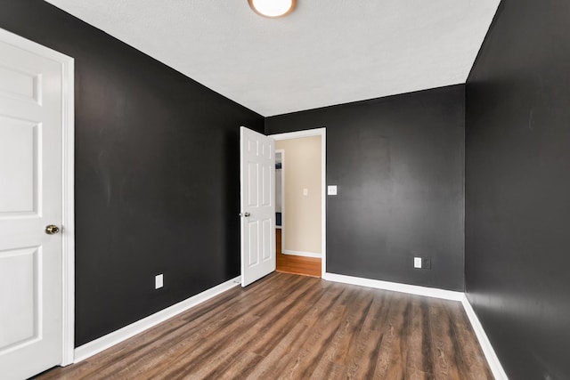 empty room featuring dark hardwood / wood-style flooring