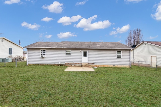 rear view of property featuring a patio and a lawn