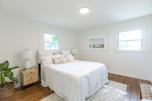 bedroom with dark hardwood / wood-style flooring