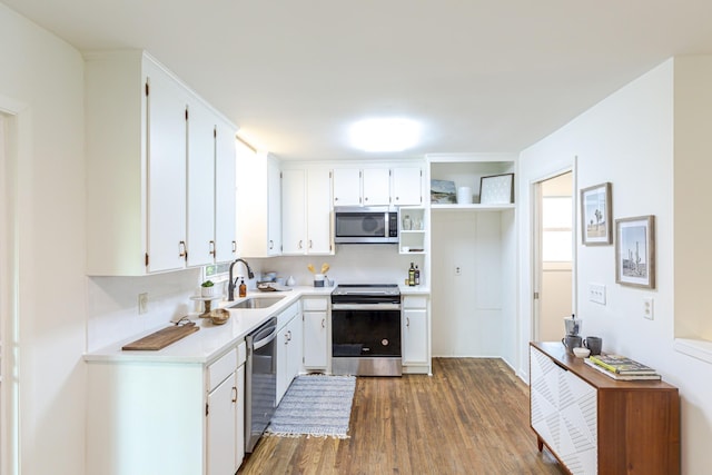 kitchen featuring sink, white cabinetry, dark hardwood / wood-style floors, stainless steel appliances, and backsplash