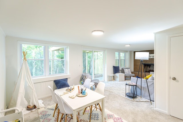 carpeted dining area with a fireplace