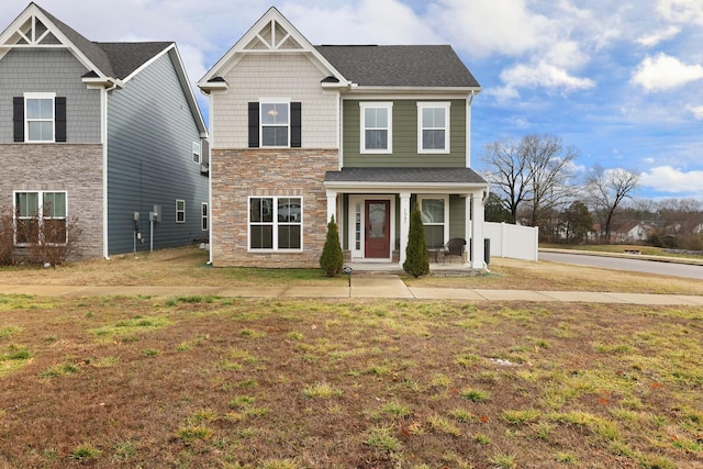 craftsman-style home featuring a front lawn