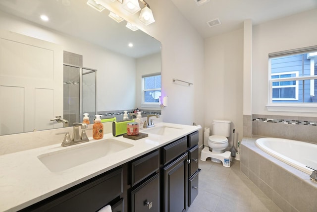 bathroom with double vanity, a sink, toilet, and a bath