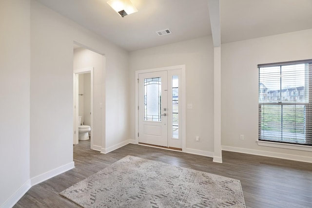 entryway featuring visible vents, baseboards, and dark wood-style flooring