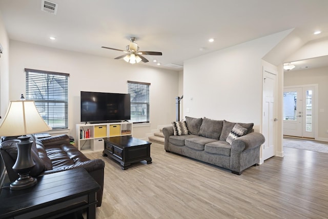 living area with light wood-style floors, ceiling fan, visible vents, and recessed lighting