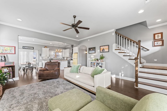 living room with crown molding, dark wood-type flooring, and ceiling fan with notable chandelier