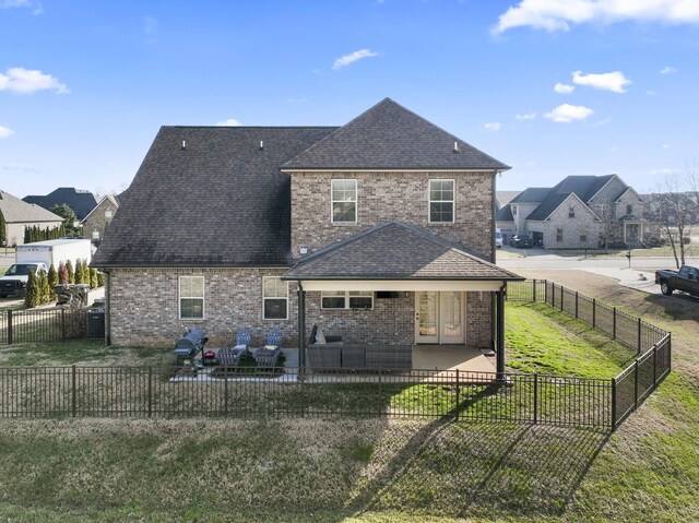 back of property featuring a lawn and a patio