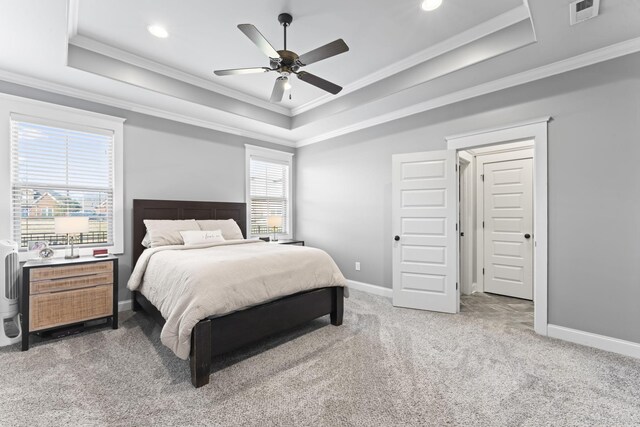 carpeted bedroom with crown molding, a raised ceiling, and ceiling fan