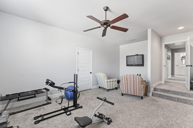 exercise room with light carpet and ceiling fan