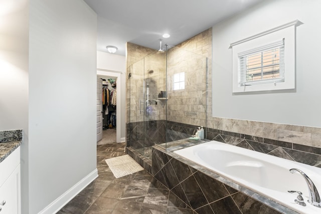 bathroom featuring vanity and shower with separate bathtub