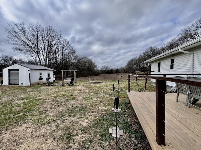 view of yard featuring an outdoor structure and a deck