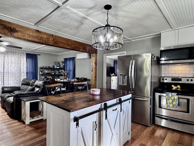 kitchen featuring wooden counters, appliances with stainless steel finishes, white cabinetry, dark hardwood / wood-style flooring, and an AC wall unit