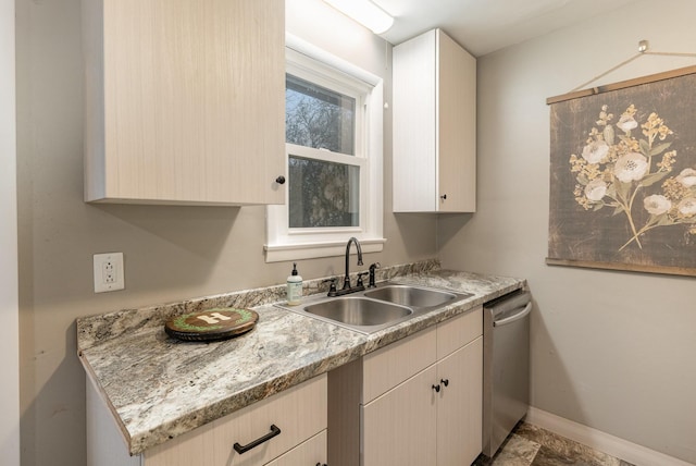 kitchen with light brown cabinetry, sink, and dishwasher